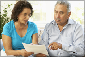 Woman interpreting a document for a man.